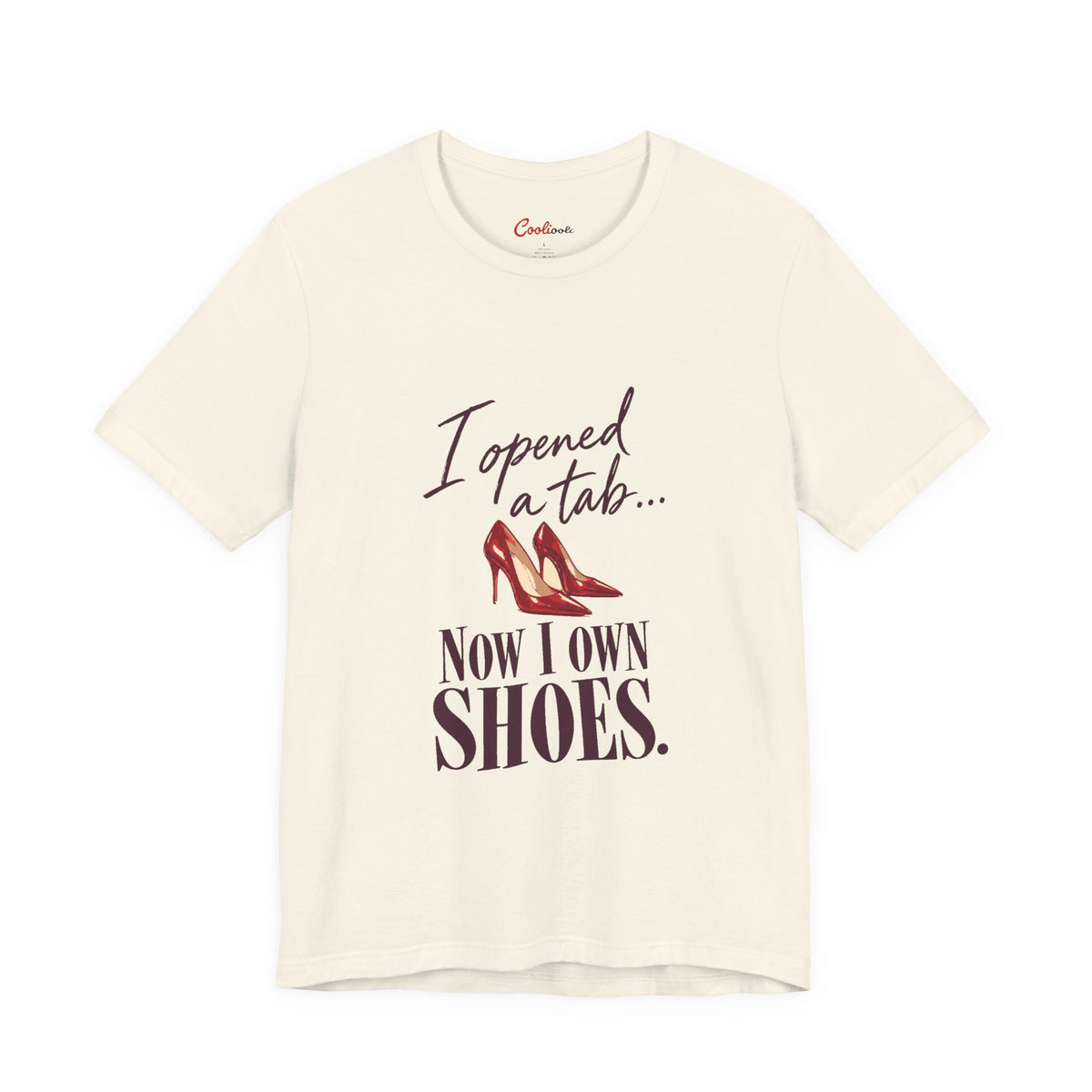 Natural Cooliooli T-shirt with red heels and “I opened a tab… Now I own shoes.” lettering, front flat lay
