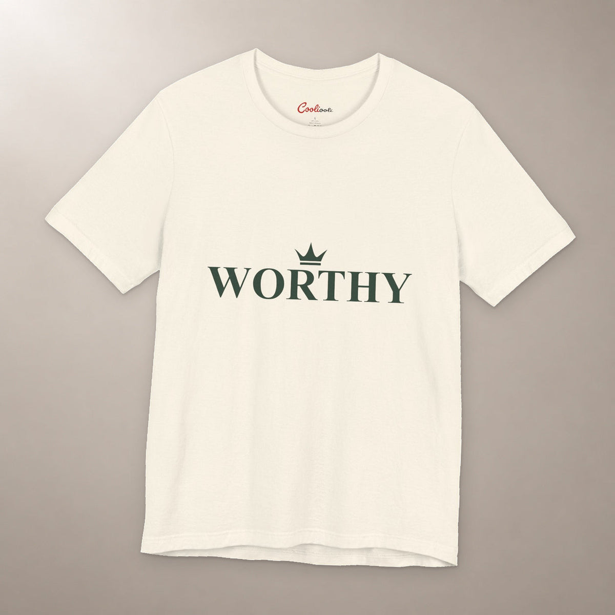 Her Worth Was Never in Question. Bella+Canvas 3001 T-shirt in Natural, front flat lay with Worthy lettering and a small crown on a plain warm neutral background.