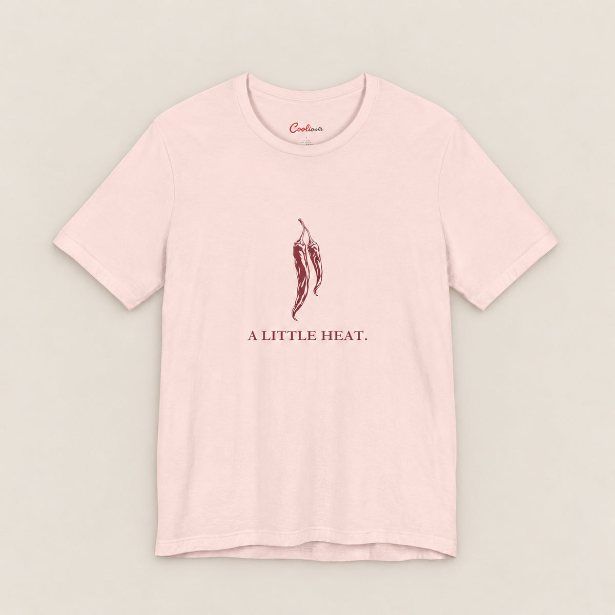 A LITTLE HEAT. Bella+Canvas3001 T-shirt in Soft Pink, front flat lay.