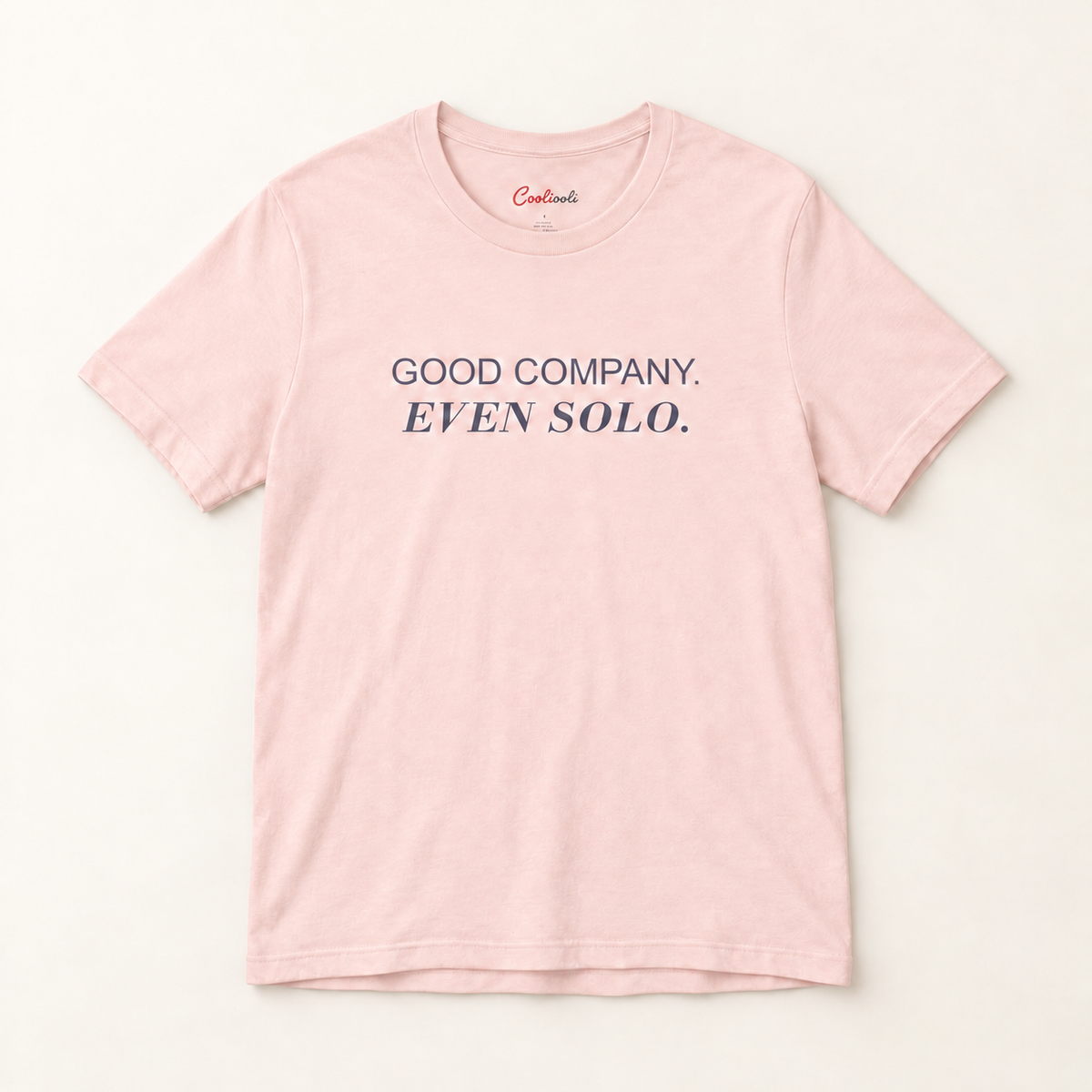 GOOD COMPANY. EVEN SOLO. Bella+Canvas 3001 tee in Soft Pink, overhead view on a plain warm neutral studio background