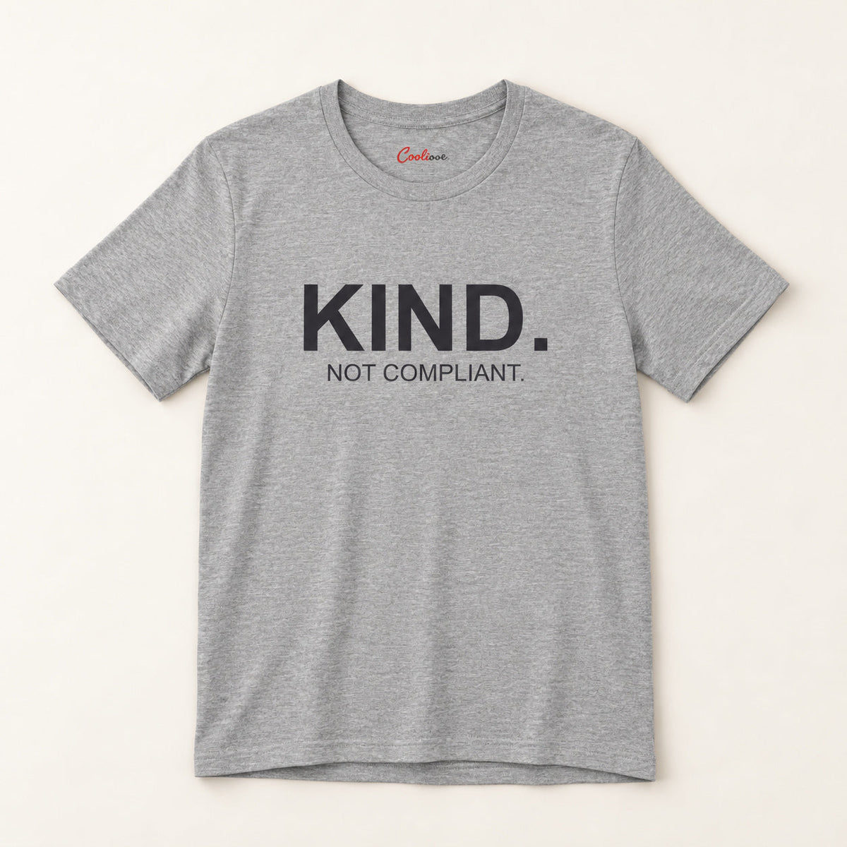 Kind. Not Compliant. affirmation tee in Athletic Heather on a neutral studio background