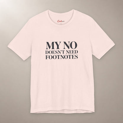 No Means No. Conversation Over. Bella+Canvas 3001 T-shirt in Soft Pink, front flat lay with My No Doesn’t Need Footnotes serif lettering on a plain warm neutral background.