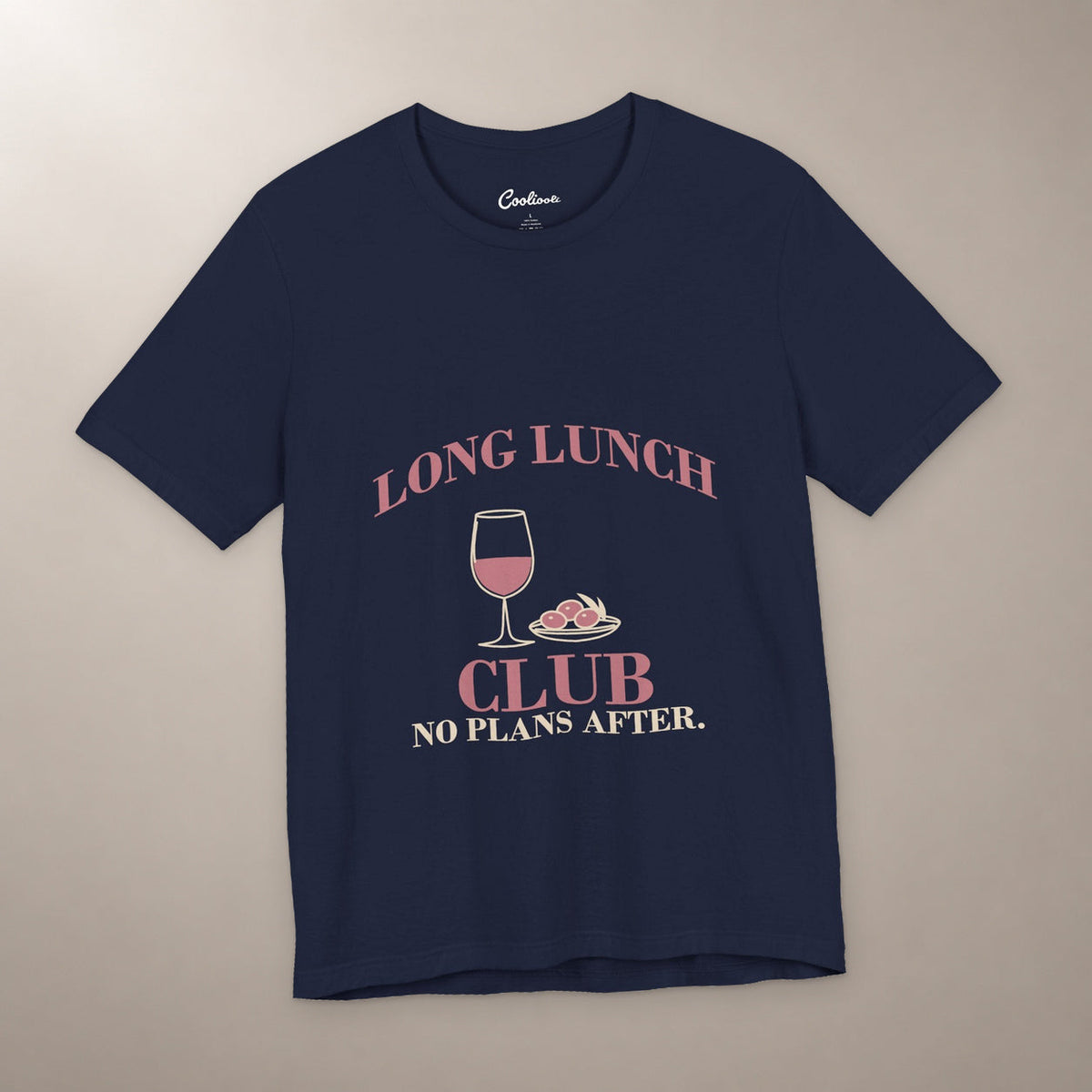 Lunch Is the Whole Agenda. Bella+Canvas 3001 T-shirt in Navy, front flat lay with Long Lunch Club, No Plans After. lettering with a wine glass and olive dish on a plain warm neutral background.