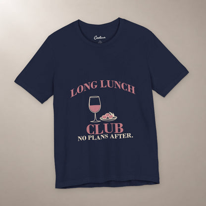 Lunch Is the Whole Agenda. Bella+Canvas 3001 T-shirt in Navy, front flat lay with Long Lunch Club, No Plans After. lettering with a wine glass and olive dish on a plain warm neutral background.