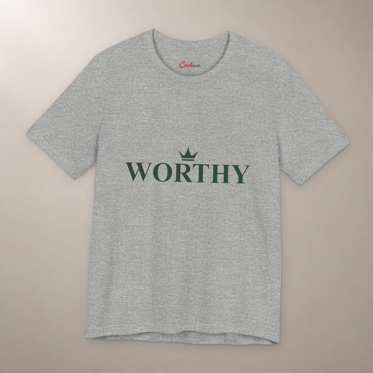 Her Worth Was Never in Question. Bella+Canvas 3001 T-shirt in Athletic Heather, front flat lay with Worthy lettering and a small crown on a plain warm neutral background.