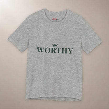 Her Worth Was Never in Question. Bella+Canvas 3001 T-shirt in Athletic Heather, front flat lay with Worthy lettering and a small crown on a plain warm neutral background.