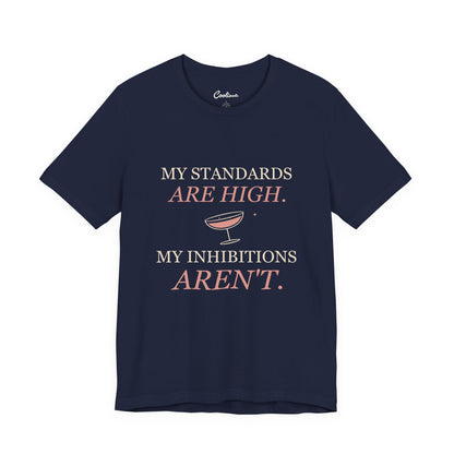 Navy Cooliooli Bella+Canvas 3001 tee with My standards are high. My inhibitions aren't. lettering and tipped cocktail coupe graphic, front flat lay.