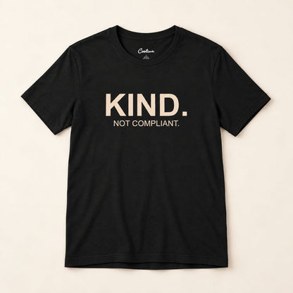 Kind. Not Compliant. affirmation tee in Black on a neutral studio background
