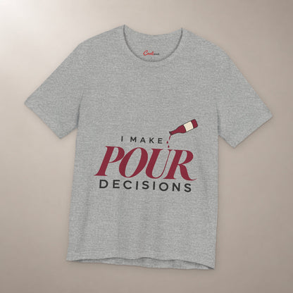 Blame the Vintage. Bella+Canvas 3001 T-shirt in Athletic Heather, front flat lay with I Make Pour Decisions lettering and a tilted wine bottle on a plain warm neutral background.