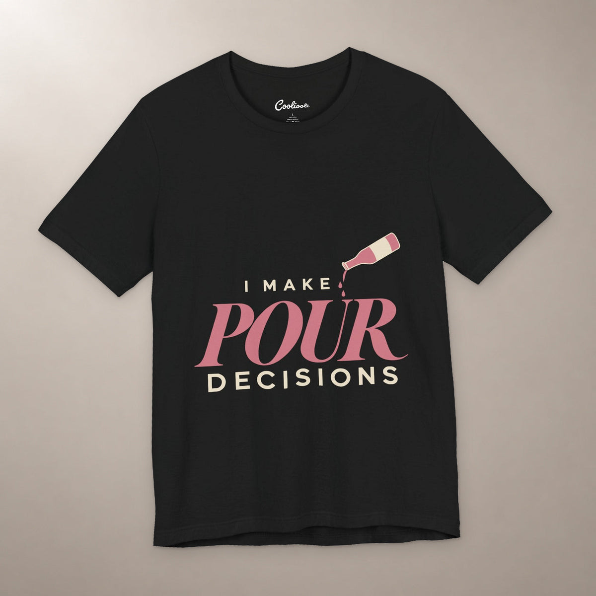 Blame the Vintage. Bella+Canvas 3001 T-shirt in Black, front flat lay with I Make Pour Decisions lettering and a tilted wine bottle on a plain warm neutral background.