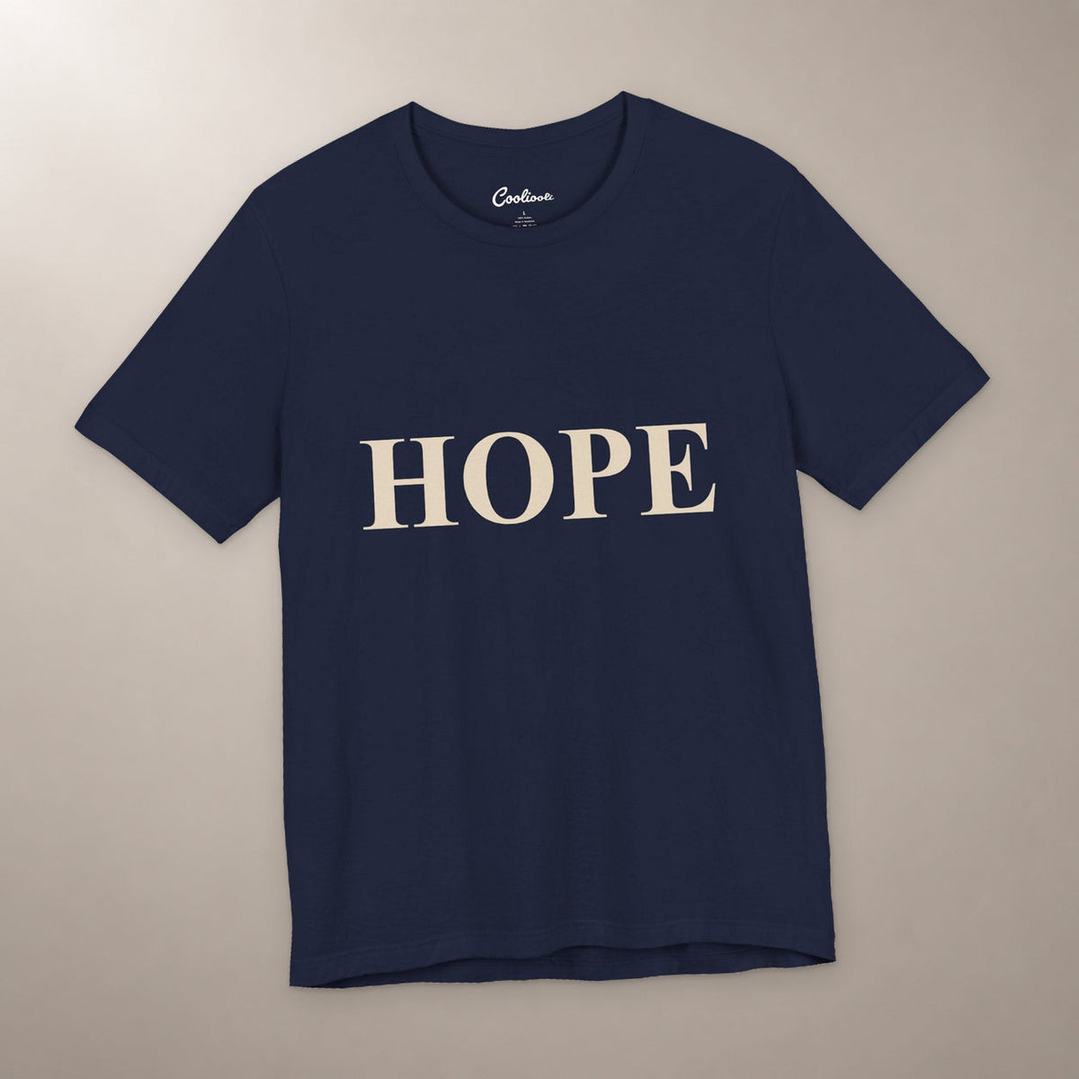 Better Days Look Good on You. Bella+Canvas 3001 T-shirt in Navy, front flat lay showing HOPE serif lettering on a plain warm neutral background.