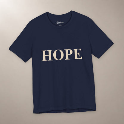 Better Days Look Good on You. Bella+Canvas 3001 T-shirt in Navy, front flat lay showing HOPE serif lettering on a plain warm neutral background.