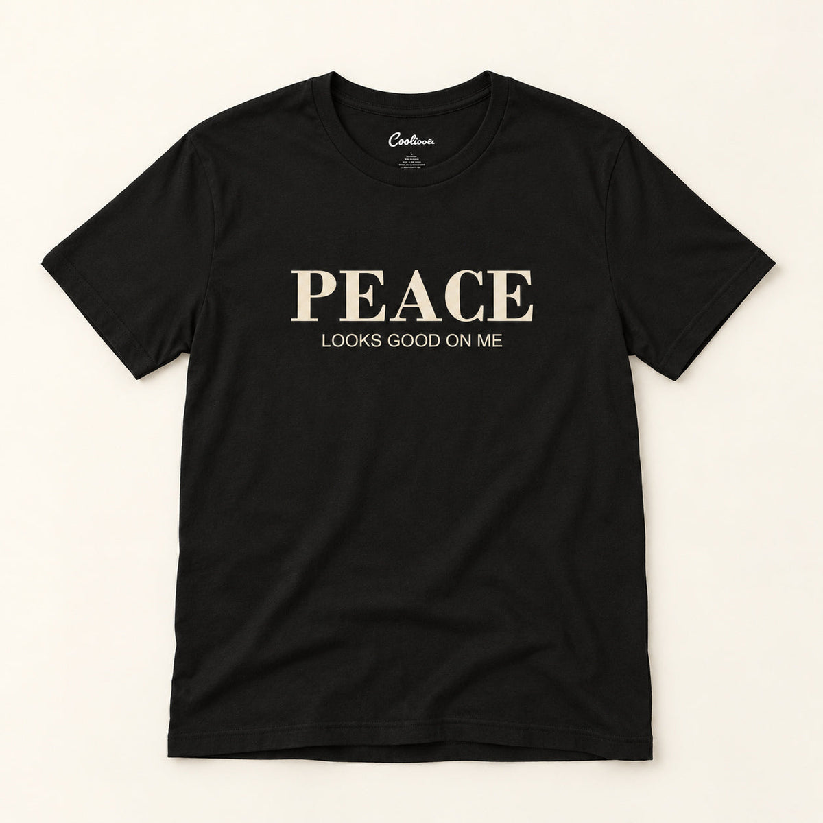 Peace Looks Good on Me affirmation tee in Black on a warm neutral studio background