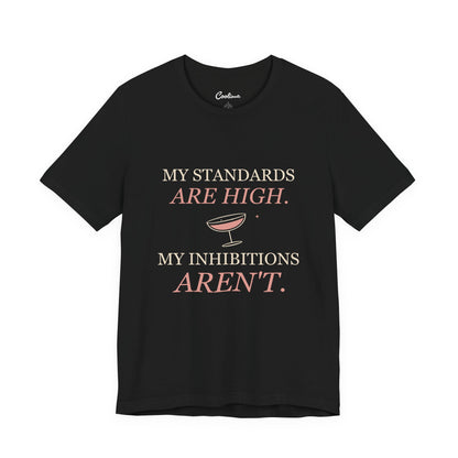 Black Cooliooli Bella+Canvas 3001 tee with My standards are high. My inhibitions aren't. lettering and tipped cocktail coupe graphic, front flat lay.