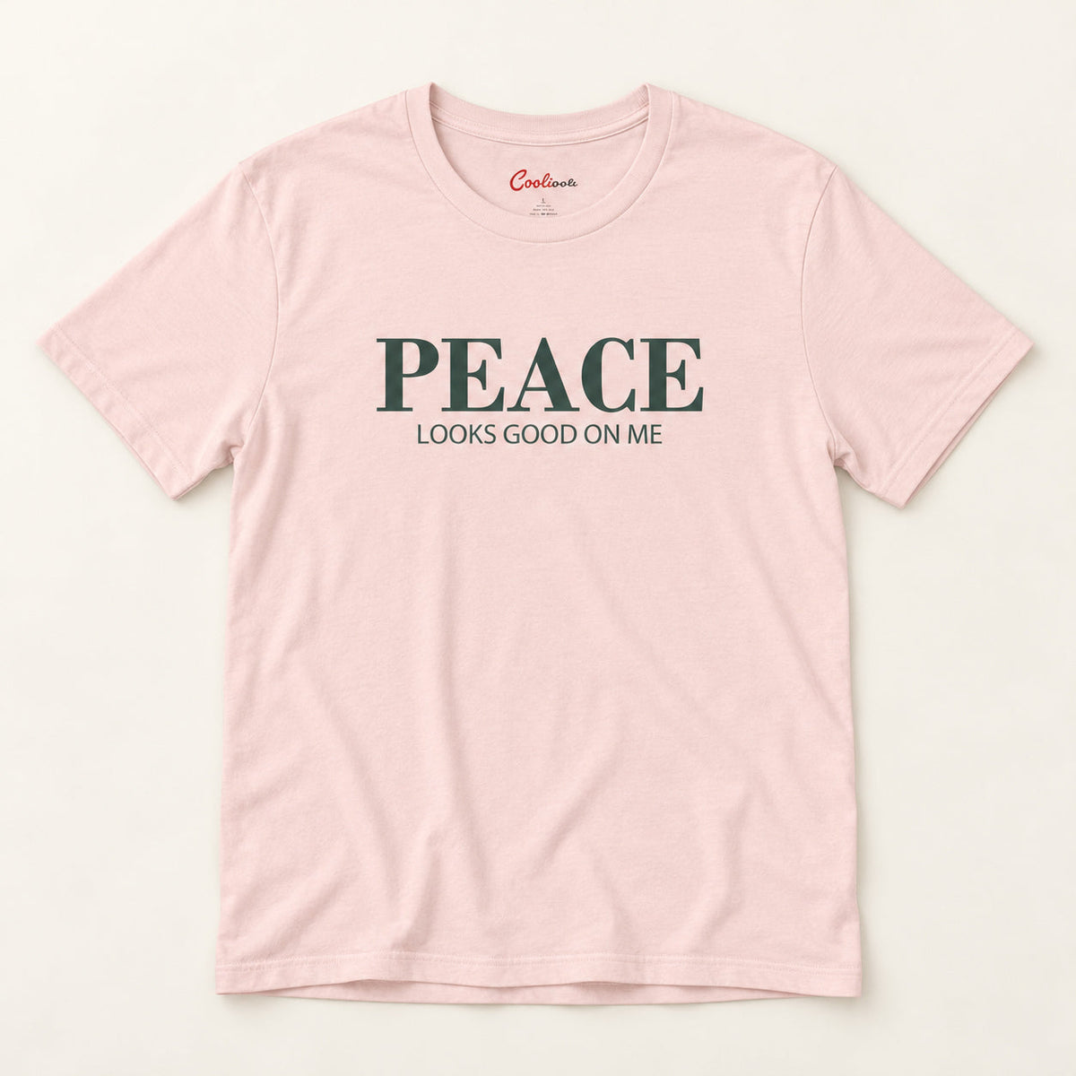 Peace Looks Good on Me affirmation tee in Soft Pink on a warm neutral studio background