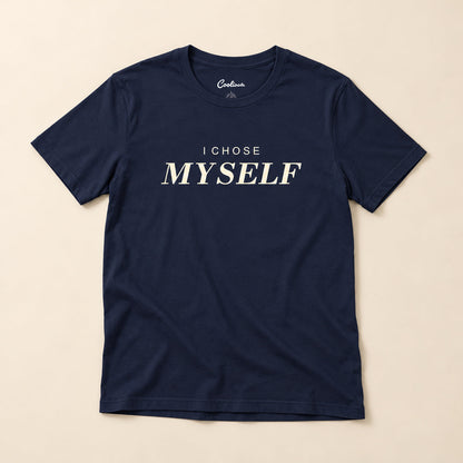 Her First Choice. Navy Bella+Canvas 3001 T-shirt with I CHOSE MYSELF lettering, complete overhead flat lay on a warm neutral background.