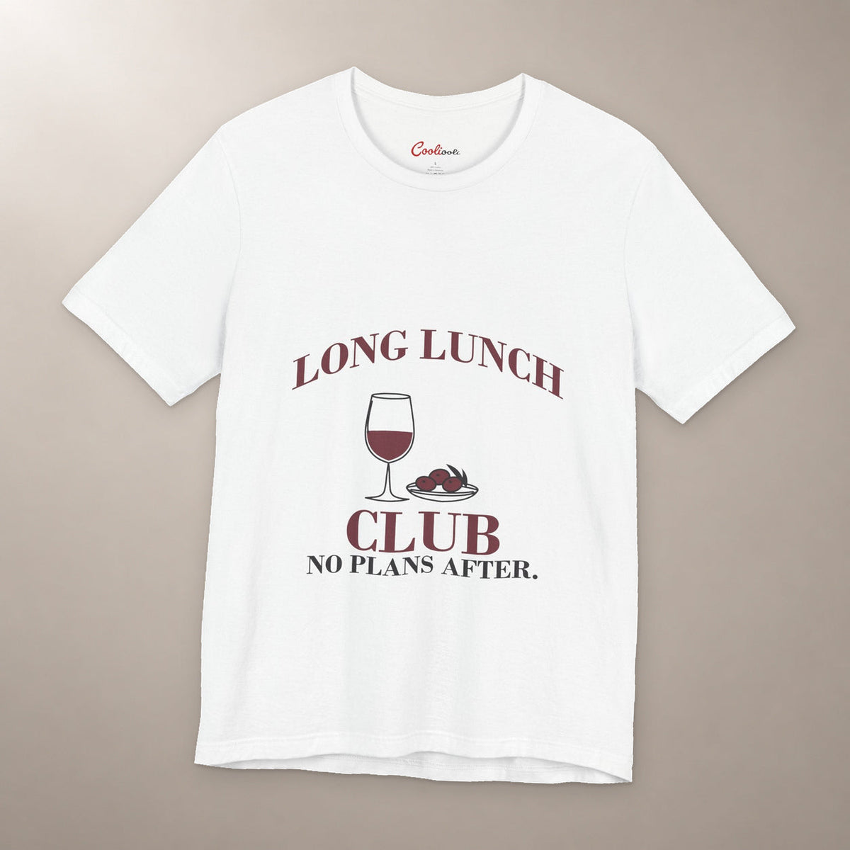 Lunch Is the Whole Agenda. Bella+Canvas 3001 T-shirt in White, front flat lay with Long Lunch Club, No Plans After. lettering with a wine glass and olive dish on a plain warm neutral background.