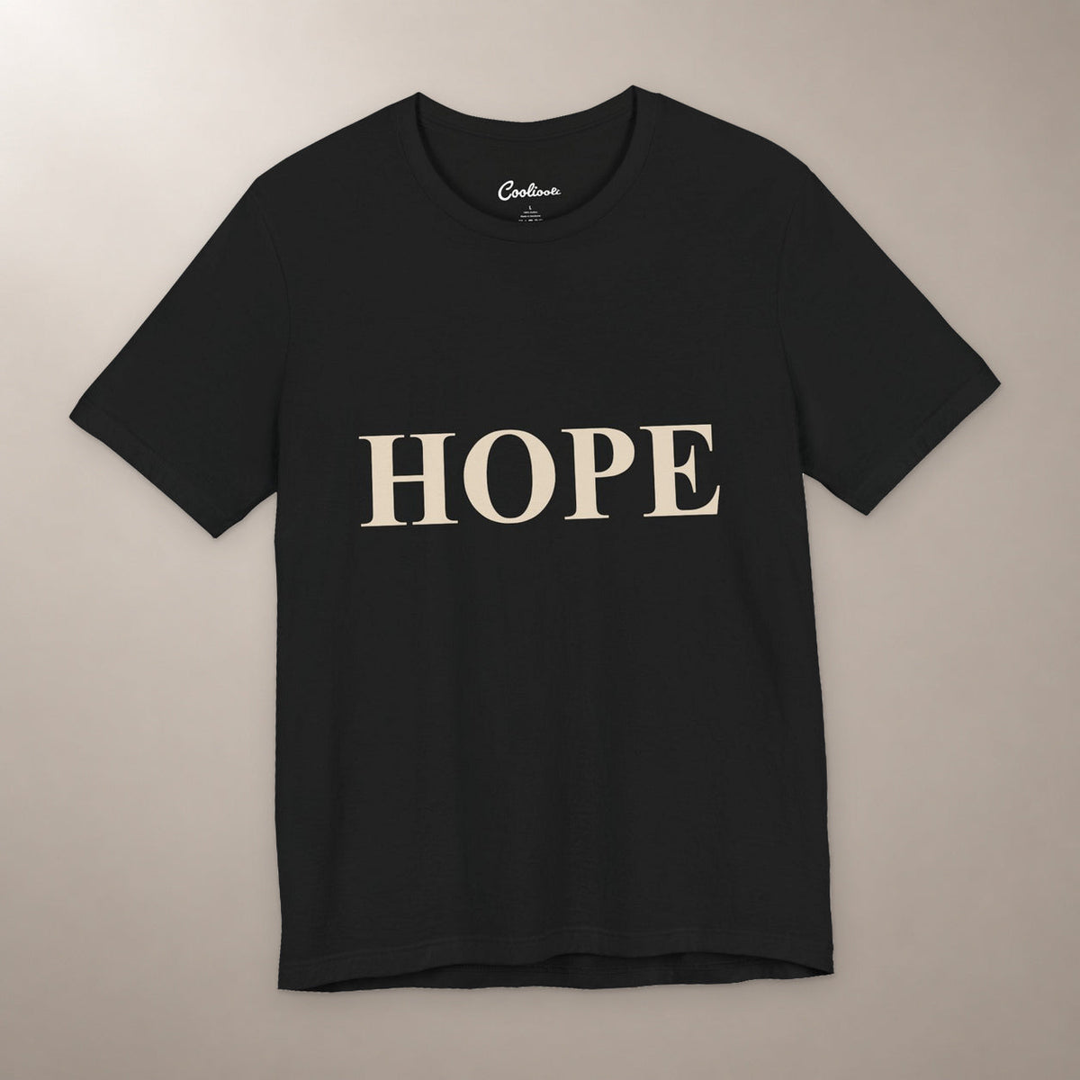 Better Days Look Good on You. Bella+Canvas 3001 T-shirt in Black, front flat lay showing HOPE serif lettering on a plain warm neutral background.