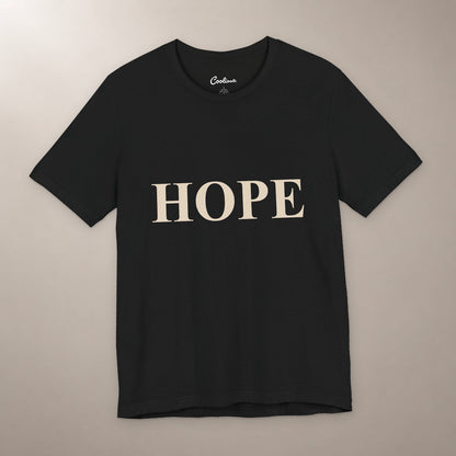 Better Days Look Good on You. Bella+Canvas 3001 T-shirt in Black, front flat lay showing HOPE serif lettering on a plain warm neutral background.