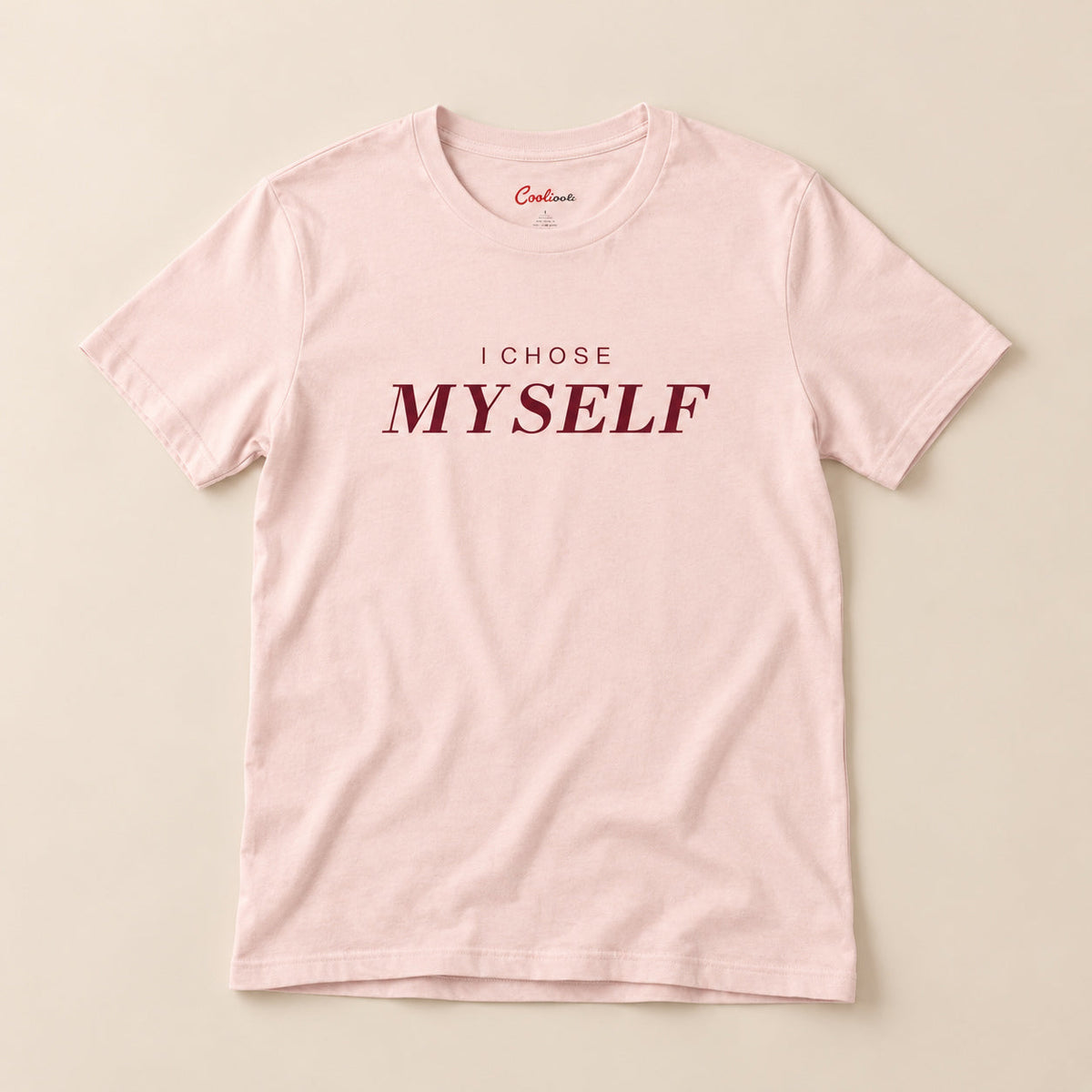 Her First Choice. Soft Pink Bella+Canvas 3001 T-shirt with I CHOSE MYSELF lettering, complete overhead flat lay on a warm neutral background.
