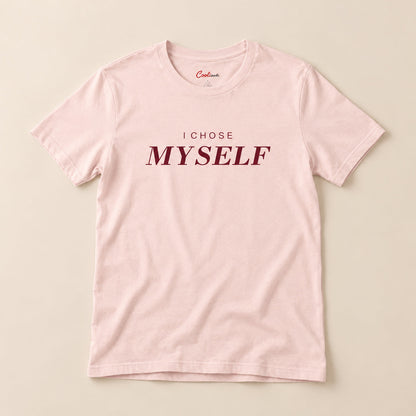 Her First Choice. Soft Pink Bella+Canvas 3001 T-shirt with I CHOSE MYSELF lettering, complete overhead flat lay on a warm neutral background.