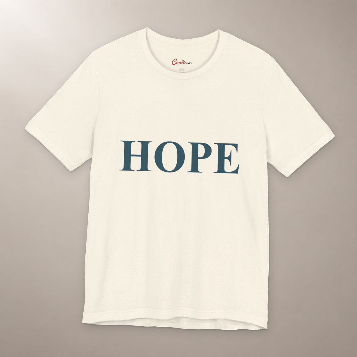 Better Days Look Good on You. Bella+Canvas 3001 T-shirt in Natural, front flat lay showing HOPE serif lettering on a plain warm neutral background.