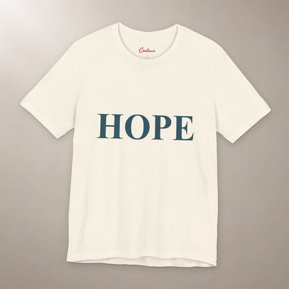 Better Days Look Good on You. Bella+Canvas 3001 T-shirt in Natural, front flat lay showing HOPE serif lettering on a plain warm neutral background.