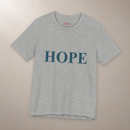 Better Days Look Good on You. Bella+Canvas 3001 T-shirt in Athletic Heather, front flat lay showing HOPE serif lettering on a plain warm neutral background.