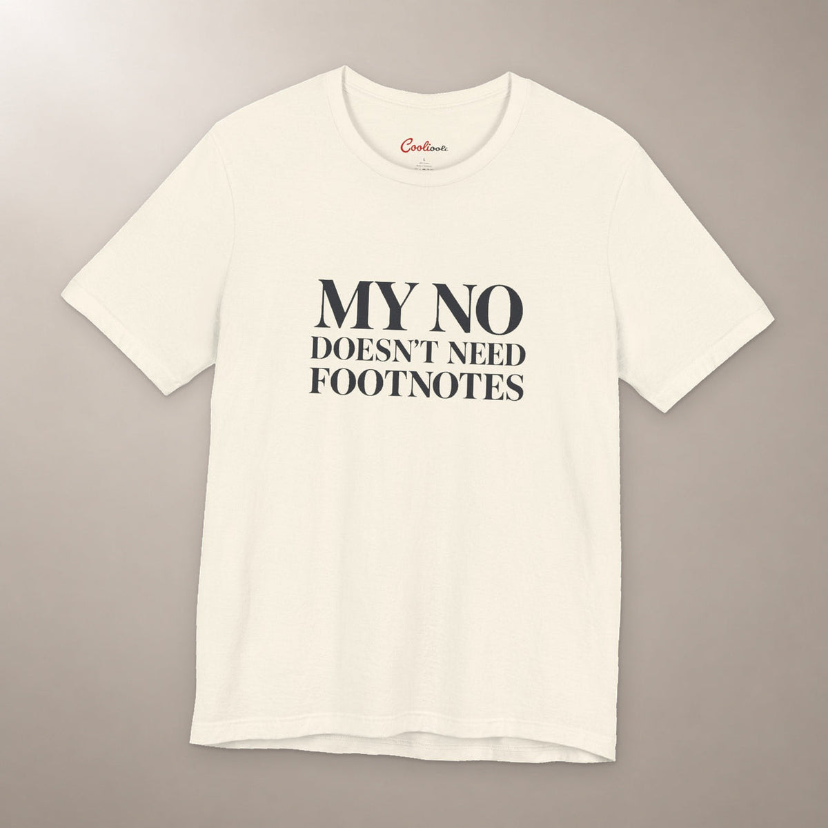No Means No. Conversation Over. Bella+Canvas 3001 T-shirt in Natural, front flat lay with My No Doesn’t Need Footnotes serif lettering on a plain warm neutral background.