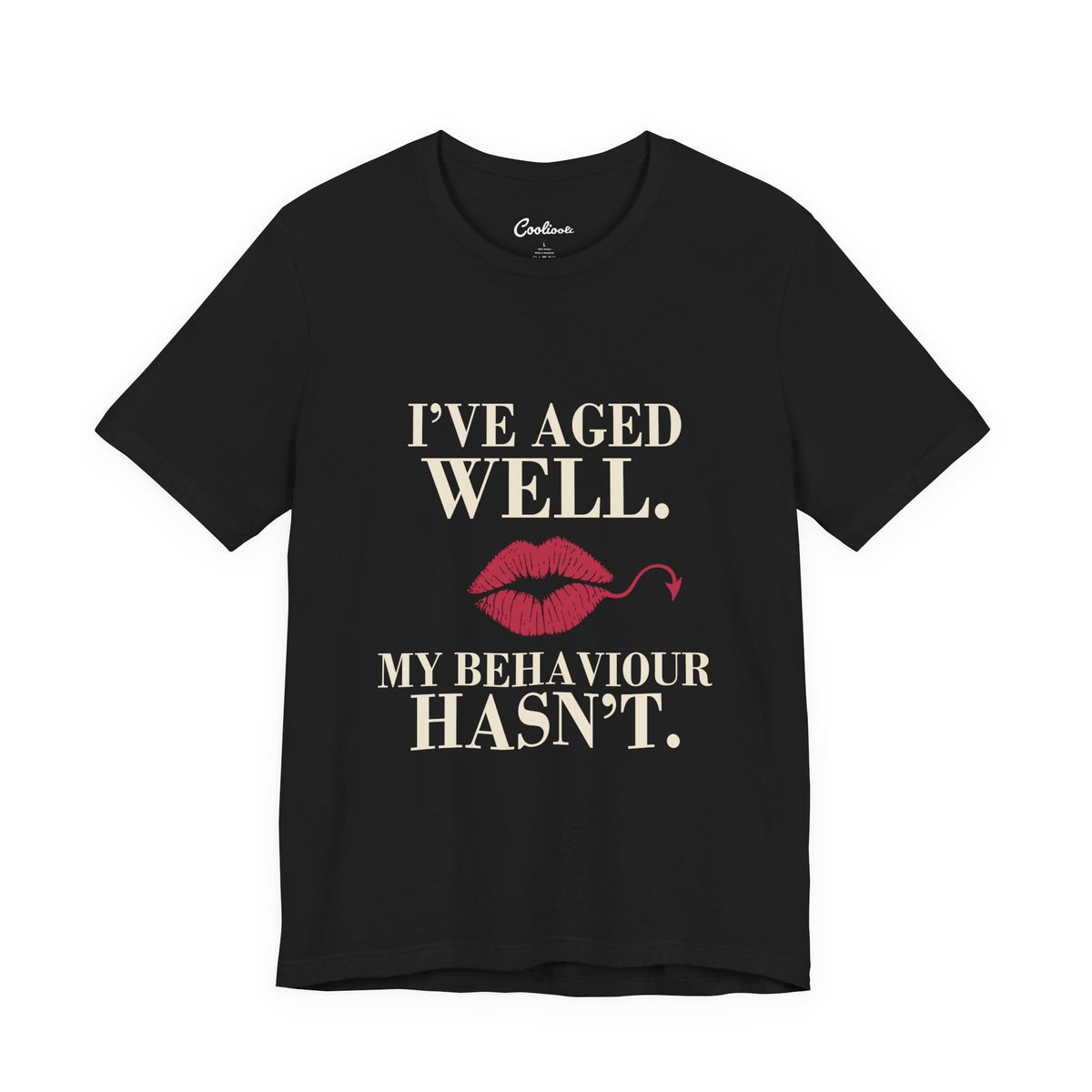 Black Cooliooli Bella+Canvas 3001 T-shirt with “I’ve aged well. My behaviour hasn’t.” lettering and lipstick kiss with devil tail, front flat lay