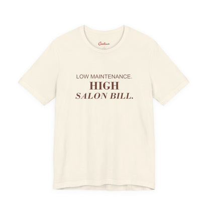 LOW MAINTENANCE. HIGH SALON BILL. on the Natural Bella+Canvas 3001 tee — accurate supplier front colour mockup