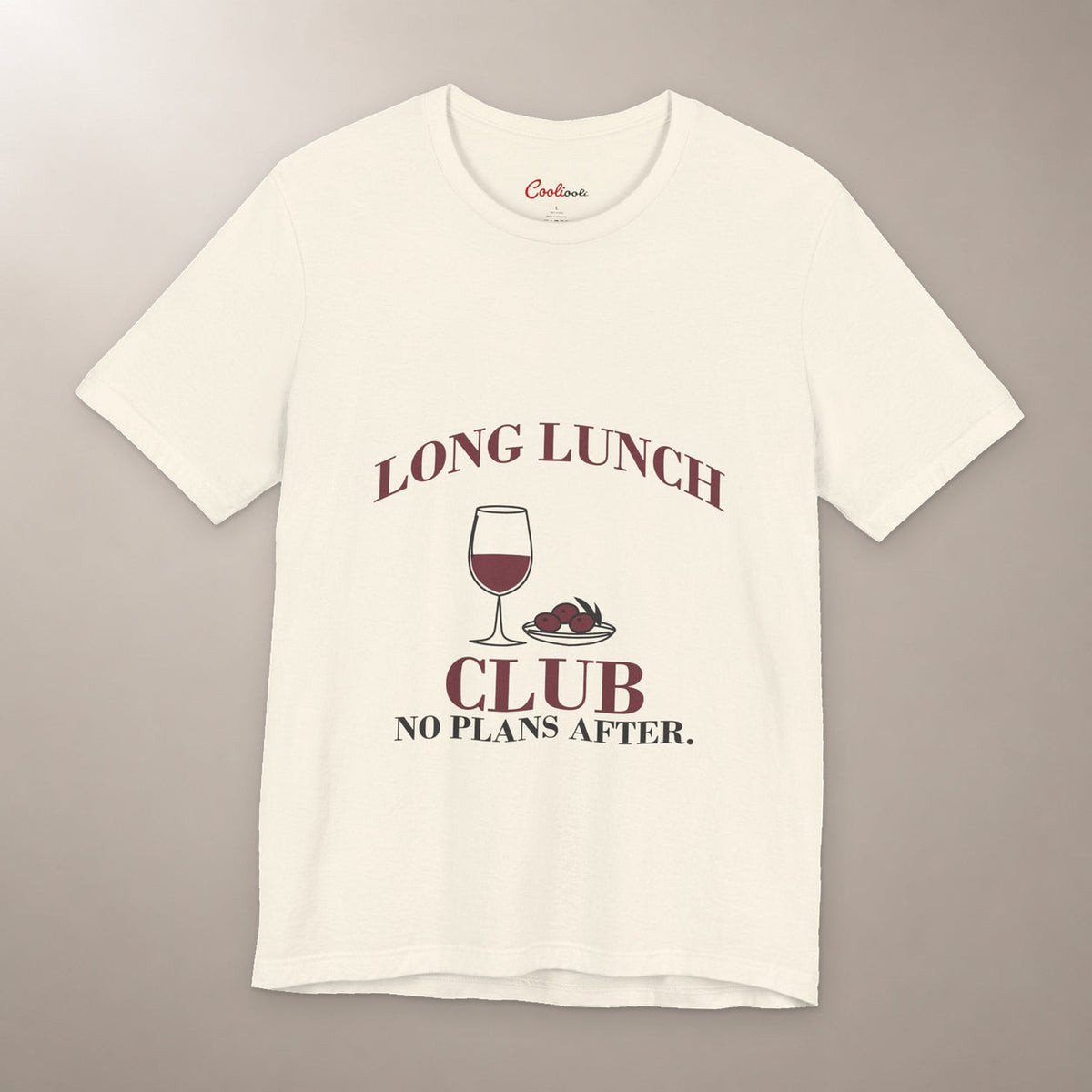 Lunch Is the Whole Agenda. Bella+Canvas 3001 T-shirt in Natural, front flat lay with Long Lunch Club, No Plans After. lettering with a wine glass and olive dish on a plain warm neutral background.