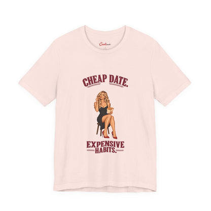 Cheap Date. Expensive Habits. Bella+Canvas 3001 T-shirt in Soft Pink, front flat lay with burgundy lettering and black dress, red heels and chips illustration.
