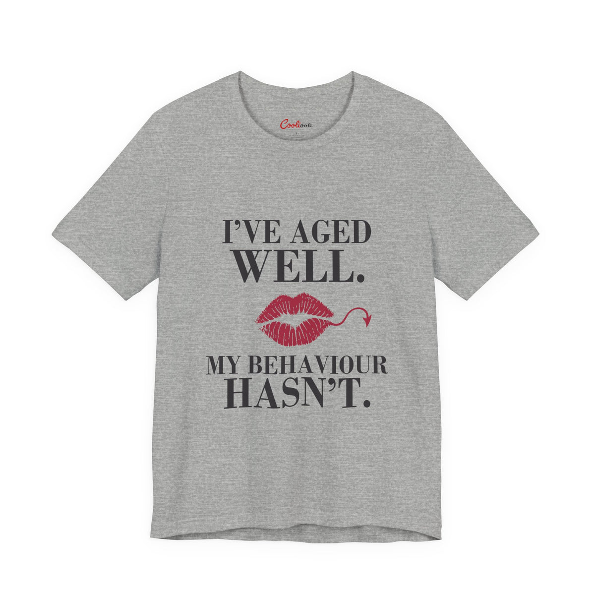 Athletic Heather Cooliooli Bella+Canvas 3001 T-shirt with “I’ve aged well. My behaviour hasn’t.” lettering and lipstick kiss with devil tail, front flat lay