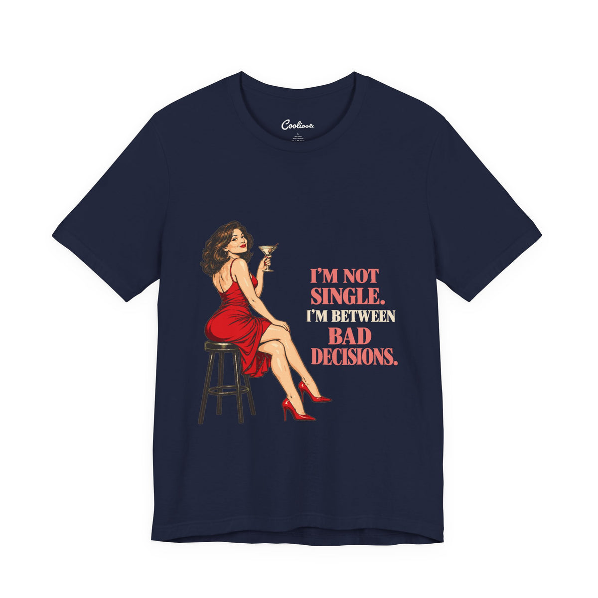 Navy Bella+Canvas 3001 tee with a woman in a red dress holding a martini and “I'm not single. I'm between bad decisions.” lettering.