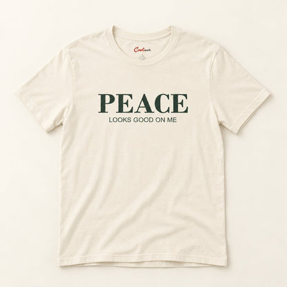 Peace Looks Good on Me affirmation tee in Natural on a warm neutral studio background