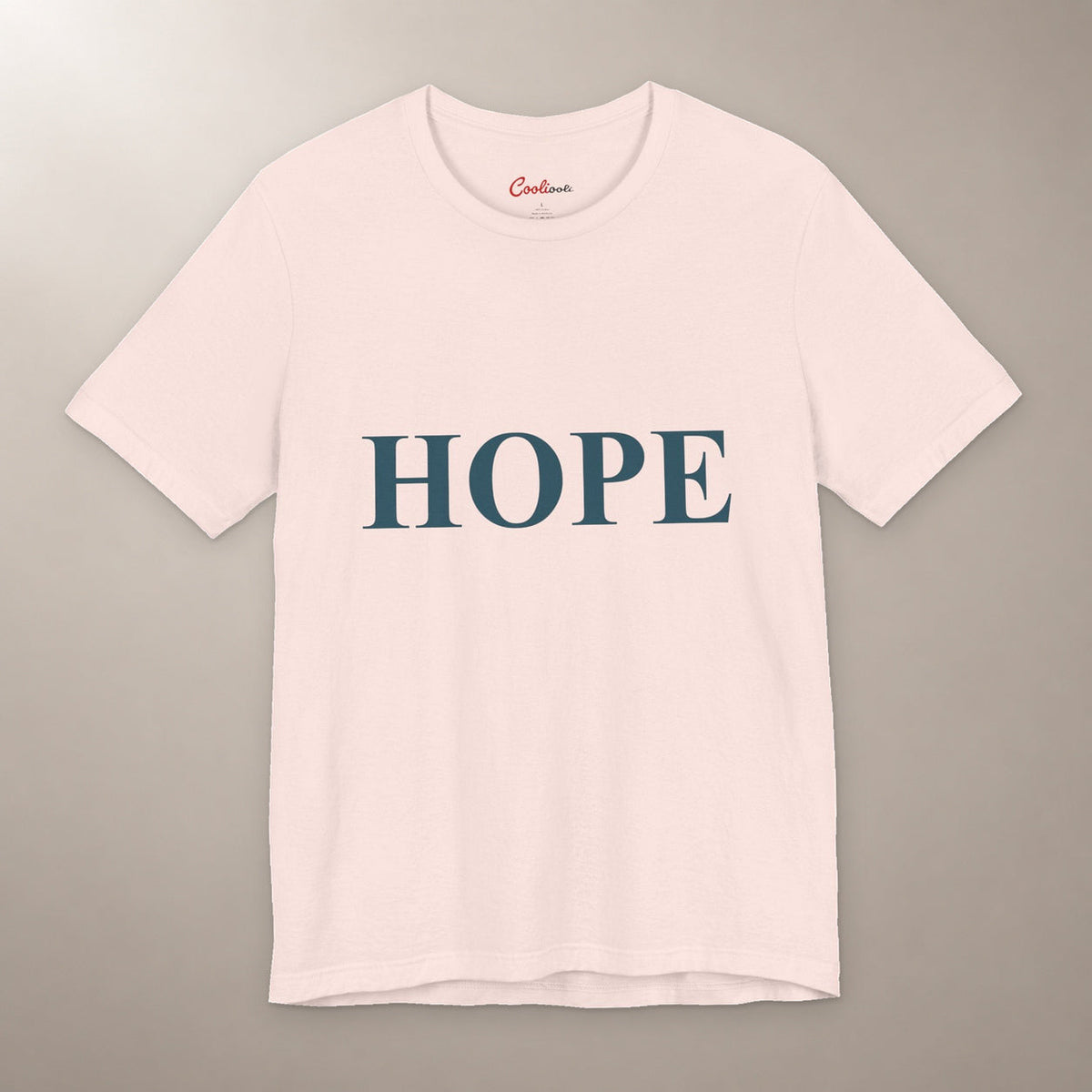 Better Days Look Good on You. Bella+Canvas 3001 T-shirt in Soft Pink, front flat lay showing HOPE serif lettering on a plain warm neutral background.