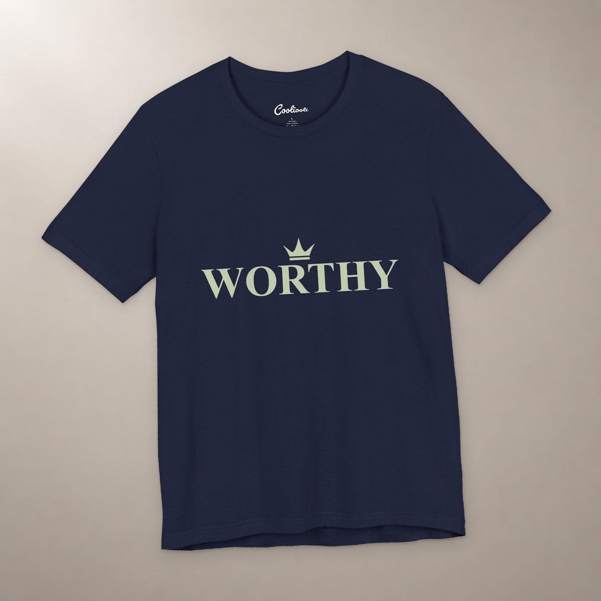 Her Worth Was Never in Question. Bella+Canvas 3001 T-shirt in Navy, front flat lay with Worthy lettering and a small crown on a plain warm neutral background.