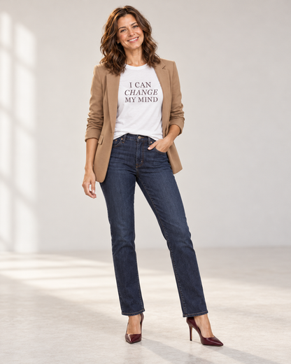 Sophie wearing the White I Can Change My Mind T-shirt with an open camel blazer, dark indigo jeans and oxblood pointed heels.