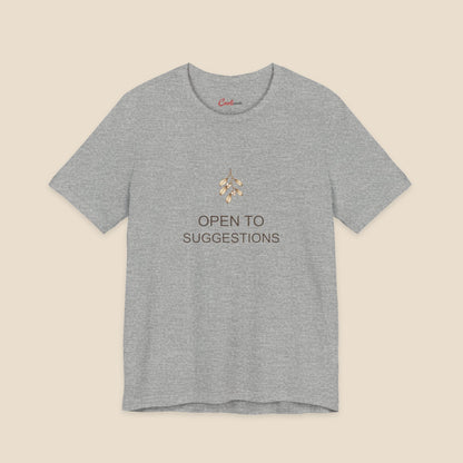 Athletic Heather Bella+Canvas3001 Christmas T-shirt with a small bronze and cream mistletoe graphic and Open to Suggestions lettering.