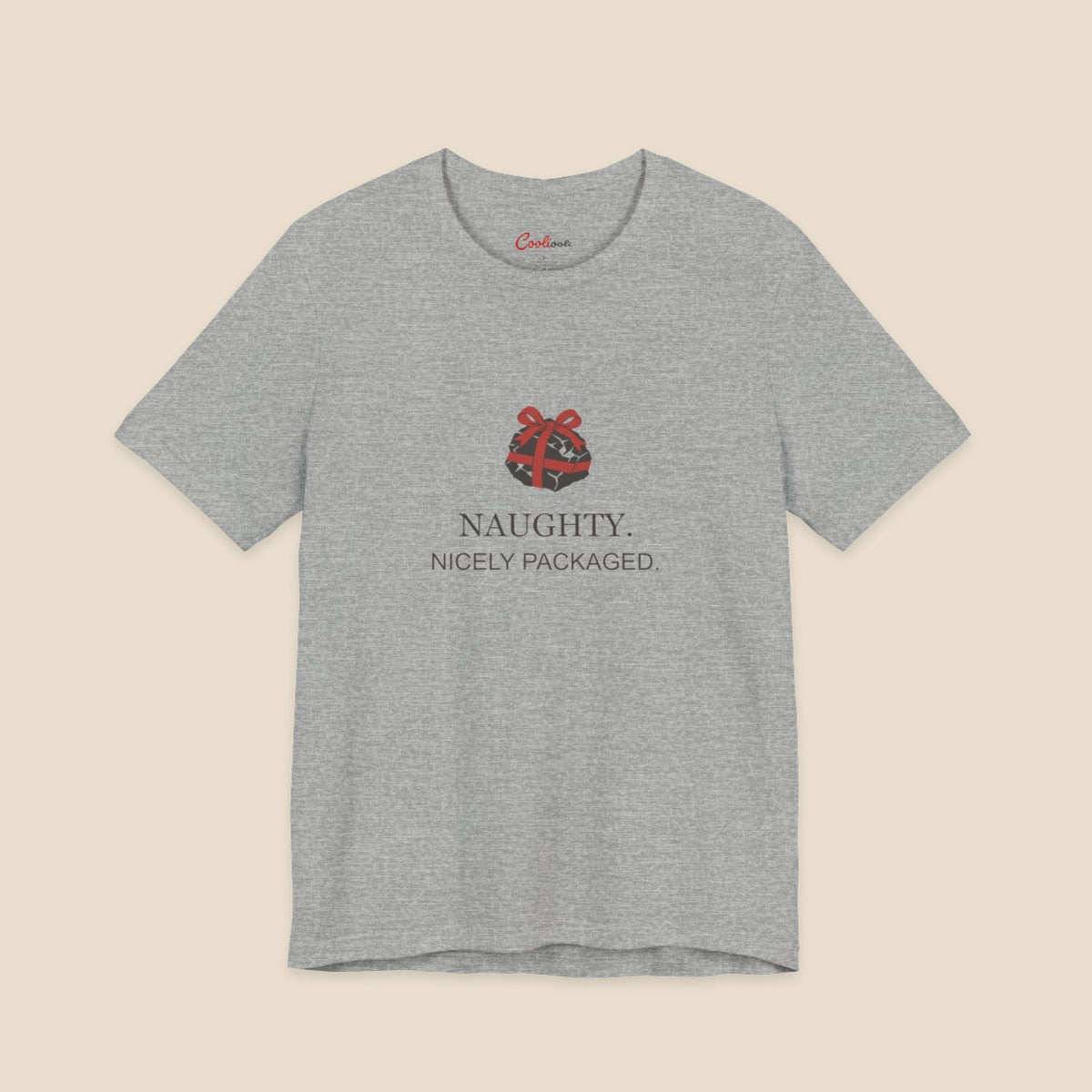Athletic Heather Bella+Canvas 3001 Christmas T-shirt with an original coal and red bow illustration above Naughty. Nicely Packaged. lettering.