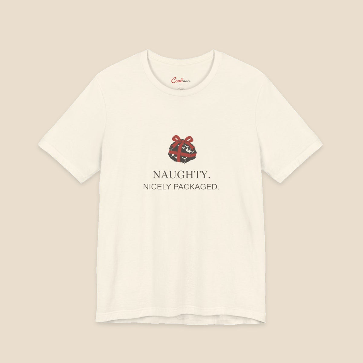 Natural Bella+Canvas 3001 Christmas T-shirt with an original coal and red bow illustration above Naughty. Nicely Packaged. lettering.