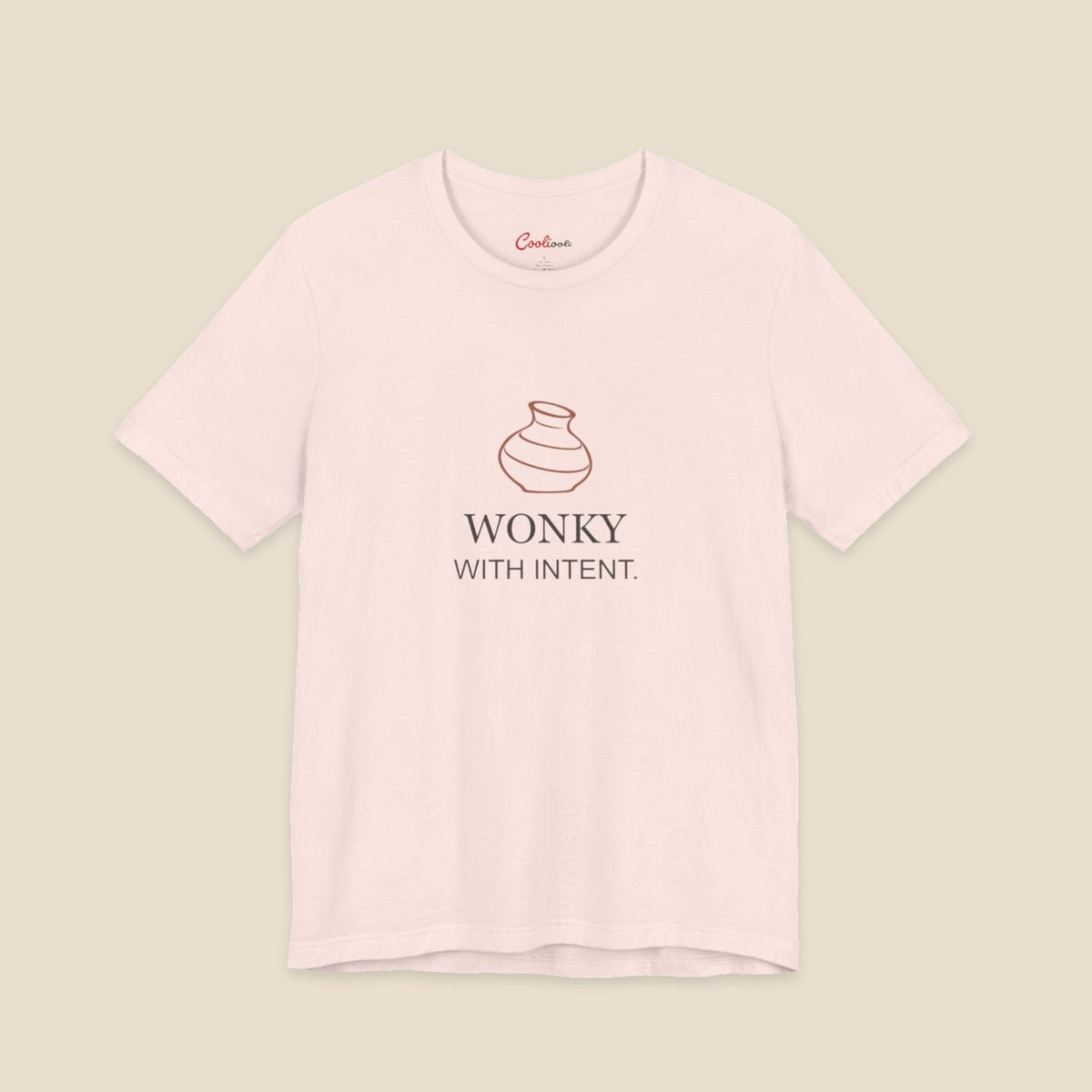 Soft Pink Bella+Canvas 3001 pottery T-shirt with an uneven terracotta vase above Wonky With Intent lettering.
