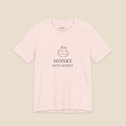 Soft Pink Bella+Canvas 3001 pottery T-shirt with an uneven terracotta vase above Wonky With Intent lettering.
