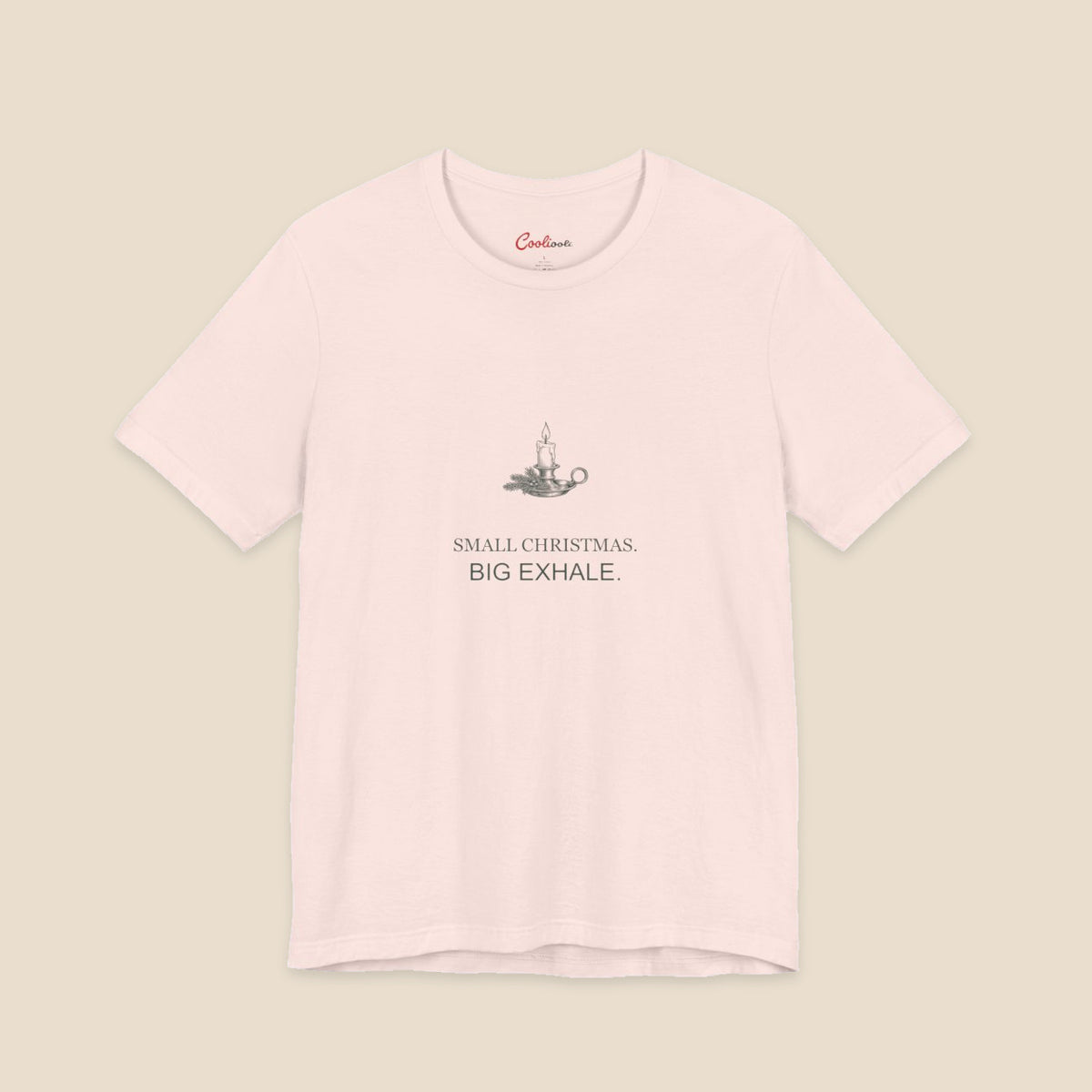Small Christmas Big Exhale candle graphic on a Soft Pink Bella+Canvas 3001 unisex tee; front colour preview.