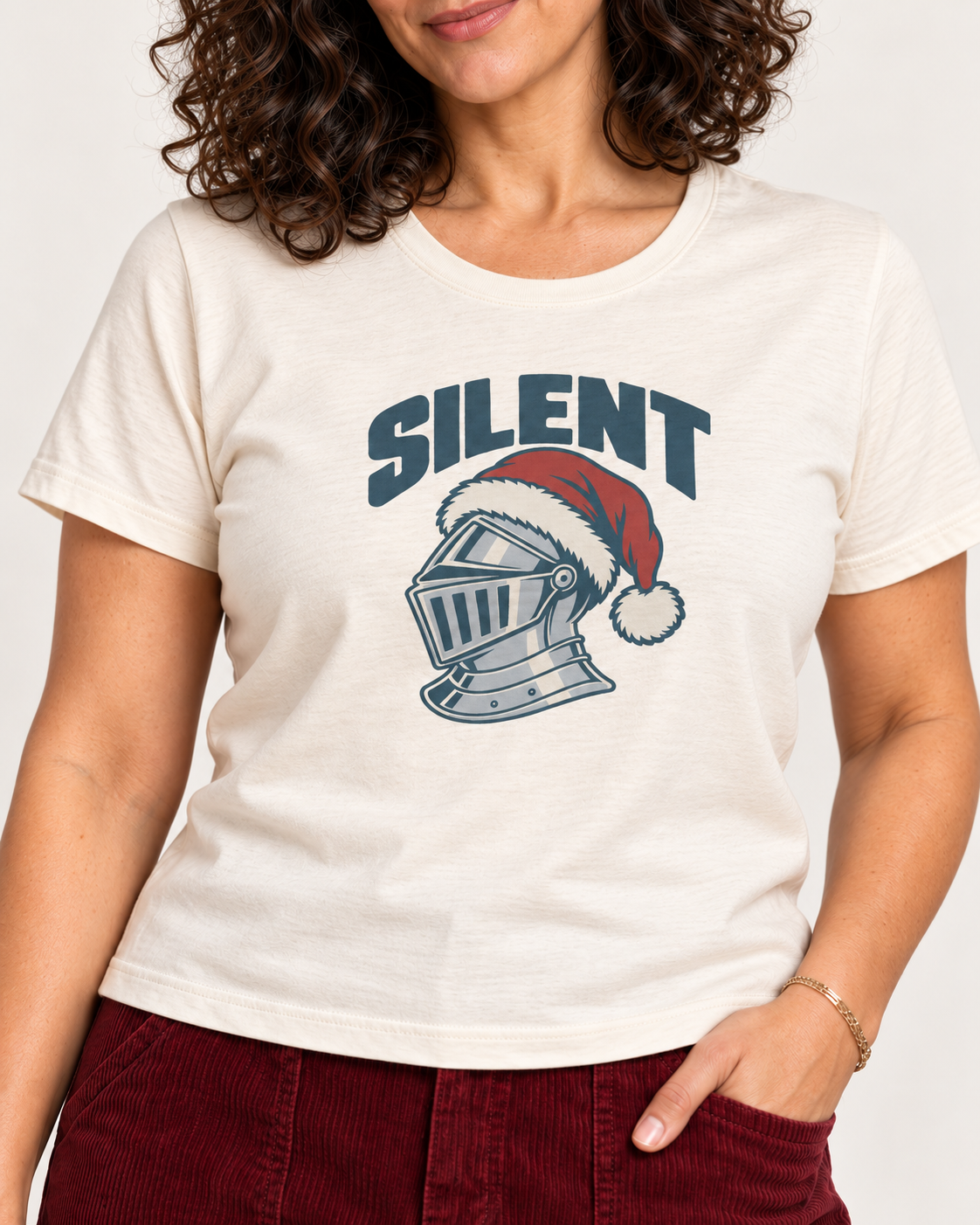 Collar-to-hip detail of the Natural Bella+Canvas 6400 women’s relaxed-fit tee, with SILENT lettering and a silver-grey knight helmet wearing a red Santa hat.