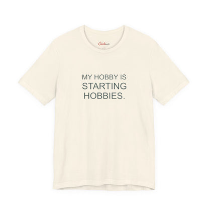 My Hobby Is Starting Hobbies Bella+Canvas3001 T-shirt in Natural, full front supplier flat lay.