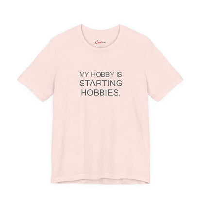 My Hobby Is Starting Hobbies Bella+Canvas3001 T-shirt in Soft Pink, full front supplier flat lay.