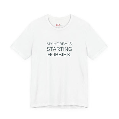 My Hobby Is Starting Hobbies Bella+Canvas3001 T-shirt in White, full front supplier flat lay.