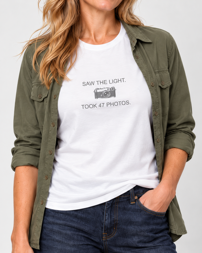 Close view of the original camera between Saw the Light and Took 47 Photos lettering on the White Bella+Canvas3001 unisex tee.
